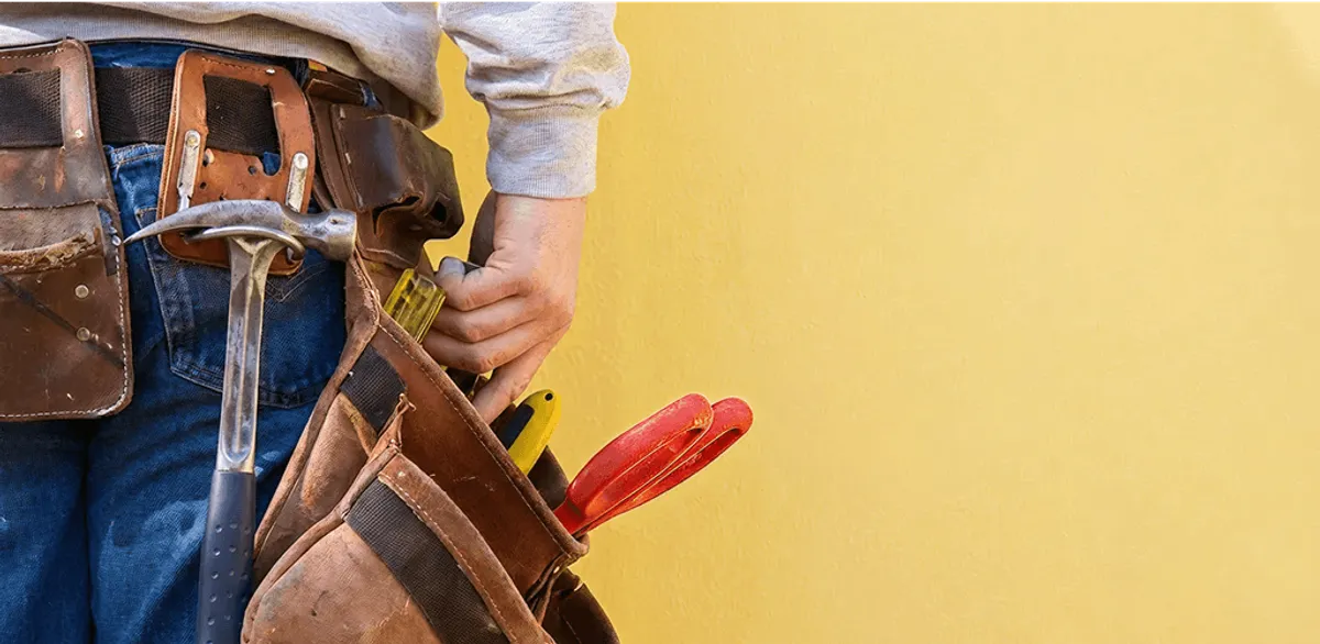Handyman with tool belt ready for home repairs and maintenance in Sacramento, CA