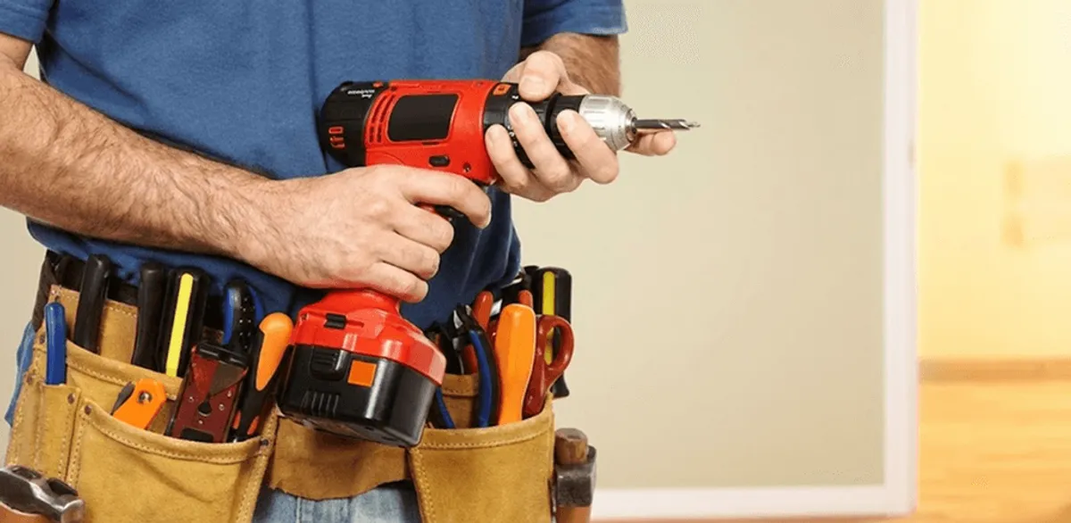 Handyman holding a power drill for home repairs and installations in Sacramento, CA